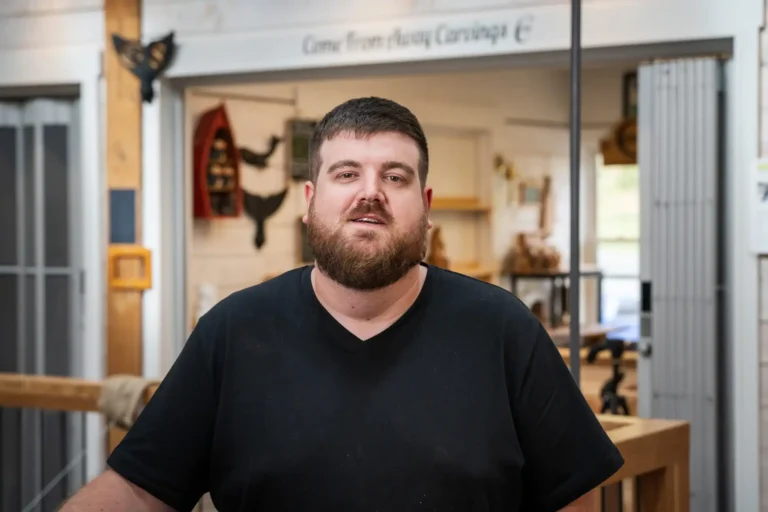 A headshot of Nathan Keil, founder of Come From Away Carvings in his studio in Newfoundland.